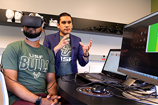 Two men in a lab with VR/set