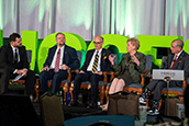President Law speaks on a panel, surrounded by four other university presidents