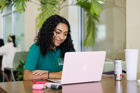 USF student using their laptop on campus.
